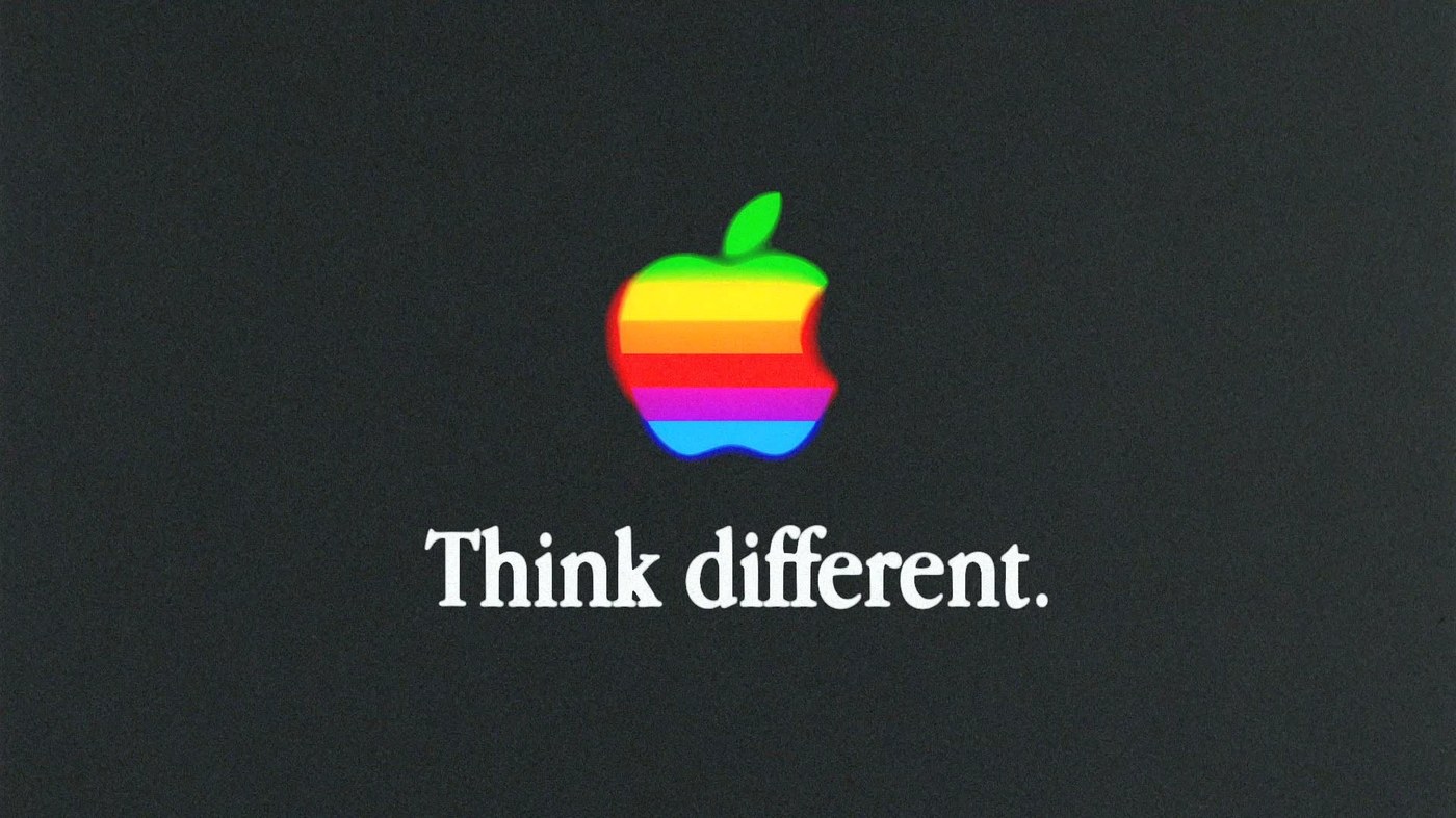 kinetic typography motion design Apple Think Different — dark charcoal grain composition with six-stripe Apple logo