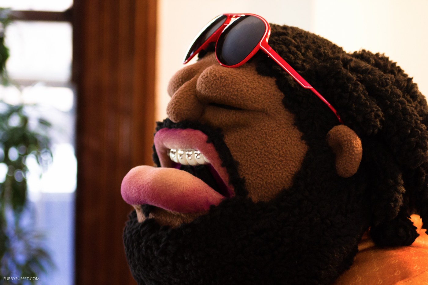 custom puppet design — character puppet with dreadlocks and red sunglasses by Furry Puppet Studio