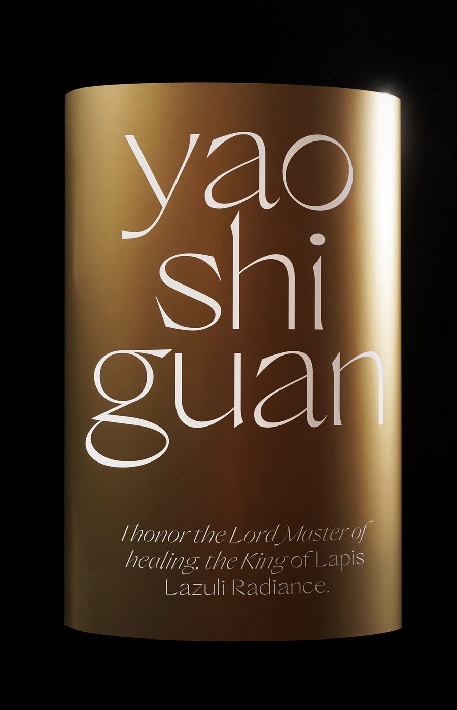 sans serif typeface printed on cylinder gold object