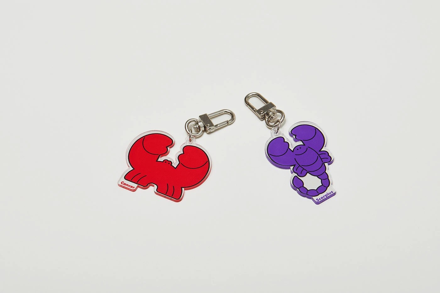 Starville constellation packaging — Cancer and Scorpius acrylic keyrings on white